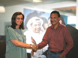 Haneen Al Rumaihi, Head Of Marketing, presenting the award to the winner Anil Pillai