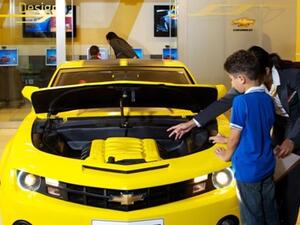 A child learning about the Chevrolet Camaro's features at Kidzania