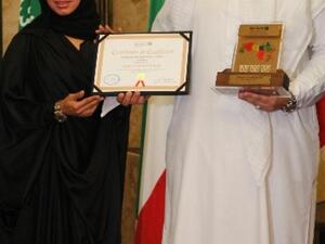 Abdulwahed Juma, Head of Corporate Affairs and Huda Abdulla, Head of Branches receive award
