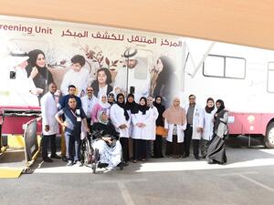 Volunteers pose for photos during the screening program