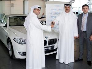 Hussain Al-Sarraf, Senior Manager, Consumer Banking Group handing over the keys to Waleed Al- Kanderi, winner of the BMW  alongside  Waleed Huwaileh, Senior Manager, Consumer Banking Group - Gulf Bank