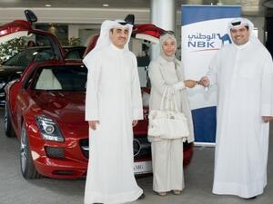 The winner Amina Al Zaidan receives the SLS keys from NBK General Manager, Consumer Banking Group Mazin Saad Al Nahedh and NBK Deputy General Manager, Consumer Banking Group Abdulla Al Najran Al Tuwaijri
