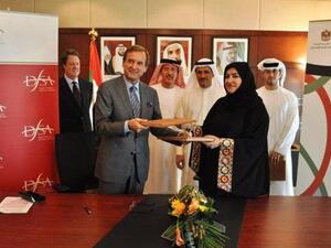 Paul Koster, Chief Executive of the DFSA, and  Fatima Mohammed Ishaq Al-Awadi, Deputy Director-General of the IA during the signing