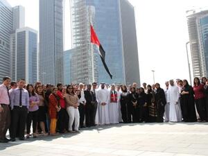 DPG CEO Khalid Al Malik and DPG staff raise the UAE Flag to Honour HH Campaign