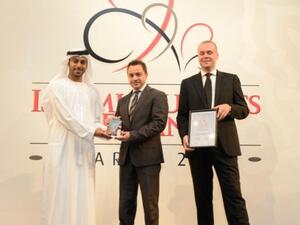 Adnan Chilwan, Deputy Chief Executive Officer, DIB (centre) receiving IB&F award 2012