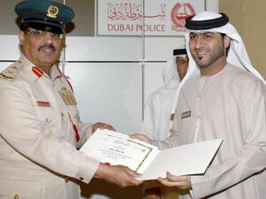 General Rashid Al Mazroui, Director-General of Supplies & Services Department, Dubai Police, presenting a special certificate of appreciation to a Tejari team member
