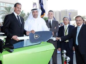 Emirates NBD top officials handing the keys of the Lamborghini Gallardo to Latif Mohammad