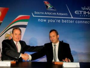 James Hogan, Etihad Airways’ President and Chief Executive Officer, and Nico Bezuidenhout, South African Airways’ acting Chief Executive Officer, celebrate the new strategic partnership