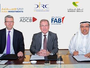 Khalid Bin Kalban, André Sayegh and Colin Fraser signing the project