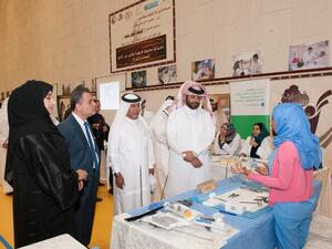 Officials visit a stand during the exhibition