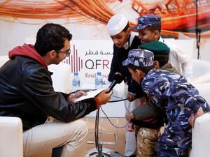 A group of young boys send a message to Qatar on National Day at the QF Radio booth at Qatar Foundation for Education, Science and Community Development’s (QF) Darb El-Saai tent.