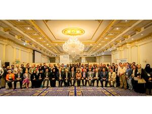 Participants and speakers at the conference pose for a group photo