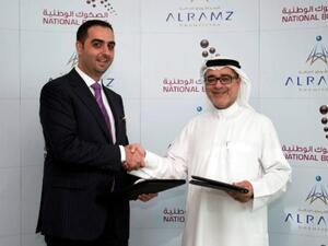 Mohammad Murtada Al Dandashi, Partner and Managing Director, Al Ramz Securities and Mohammed Qasim Al Ali, CEO of National Bonds Corporation shaking hands