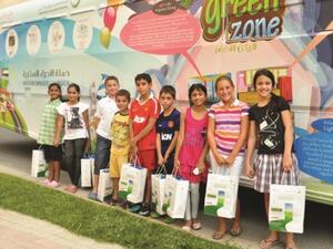 ‘Green Zone’ DEWA bus with children from the Shorooq community