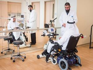 Basem Owais, Physical Therapist, conducts a physical therapy session in the QRI gymnasium with patient Jassim Mohammed Ali Abdulla