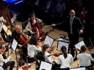 Qatar Philharmonic Orchestra’s (QPO) principal viola, Giovanni Pasini, conducting a joint orchestra