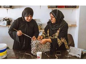 Syrian refugee Sahira Zoubi works on a new handbag, made from recycled newspapers, at an up-cycling workshop in Irbid city, northern Jordan, May 9, 2018. (JT)