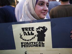 A woman holds up a sign at a demonstration in Cairo demanding freedom for all political prisoners in July 2012. (AFP/Gianluigi Guerci)