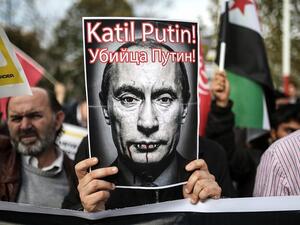 A protester holds a poster depicting Russian President Vladimir Putin and reading “Putin, killer!” during a demonstration in Istanbul, on November 27, 2015. (AFP/ Cagdas Erdogan) A protester holds a poster depicting Russian President Vladimir Putin and reading “Putin, killer!” during a demonstration in Istanbul, on November 27, 2015. (AFP/ Cagdas Erdogan)