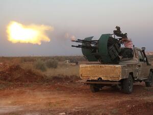 Rebel fighters fire a heavy machine gun during clashes with Syrian pro-government forces on the frontline facing Deir al-Zoghb, a government-held area in the northwestern Idlib province, on Aug. 31, 2015. (AFP/Omar Haj Kadour)