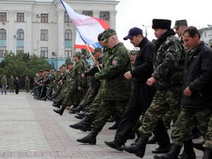 Russian soldiers and pro-Russian volunteers during a military parade rehearsal in preparation for the Victory Day parade in Simferopol, Crimea, on April 12, 2014. (AFP/Yuri Lashov)