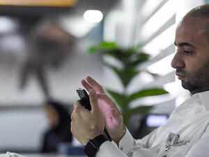 A man playing with his phone (AFP/File Photo)