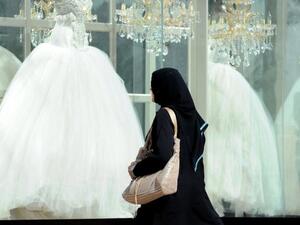 A Saudi woman looks at wedding dresses in a shop. (AFP/File)