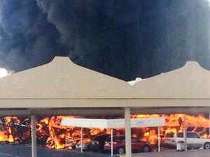 Firefighters controlled the blaze that engulfed 19 cars in a University of Sharjah parking lot. (Twitter)
