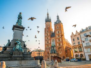 Old city center view with Adam Mickiewicz monument, St. Mary's Basilica and birds flying in Krakow (Shutterstock)