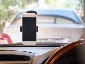 “Installation of a tool or a device to place the mobile phone or any other electronic device for the driver use will attract (a fine of) 15 rial with one black point,” according to the new law (Shutterstock/File)