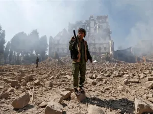 Houthi rebel fighters inspect the damage after a reported air strike carried out by the Saudi-led coalition targeted the presidential palace in the Yemeni capital Sanaa on Dec. 5. (AFP/ File)