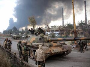 Syrian government forces patrol near Aleppo's thermal power plant after they took control of the area on the eastern outskirts of Syria's northern embattled city from Islamic State (IS) group fighters on February 21, 2016. (AFP/George Ourfalian)