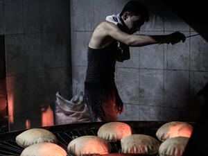 A Syrian man works at a bakery in the rebel-held town of Douma, east of the capital Damascus . (AFP/File)