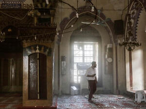 People search for injured people inside a mosque after it was hit by a rocket fired into Turkey from an area of Syria controlled by the Islamic State. (AFP/File)