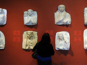A woman looking at exhibits in the Palmyra Hall at the State Hermitage Museum in St. Petersburg. (AFP/File)