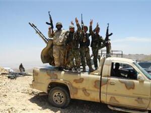 A handout picture released by the Syrian Arab News Agency (SANA) on June 6, 2015 shows Syrian pro-government fighters flashing the sign for victory at a hilltop in the Qalamoun region on the outskirts of the Syrian capital Damascus. (AFP/File)