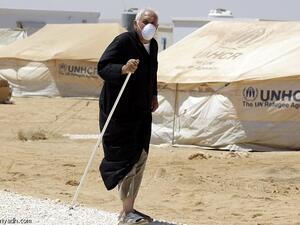 A Syrian refugee walks after undergoing a medical check at a Moroccan military field hospital in the Zaatari camp for Syrian refugees, on Aug. 11, 2012. (AFP/Khalil Mazraawi)