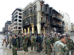 Syrian government forces gather on a street in the old city of Homs on 8 May 2014. (AFP/File)