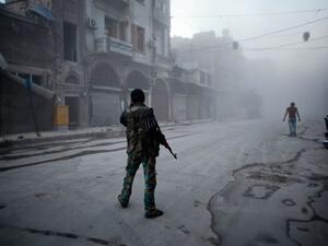 A Syrian rebel stands in the street in Aleppo. (AFP/Ahmed Deeb)