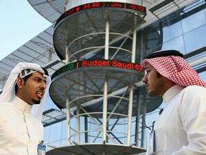 Saudi men chat outside the Saudi Stock Exchange in Riyadh. (AFP/ File) Saudi men chat outside the Saudi Stock Exchange in Riyadh. (AFP/ File)