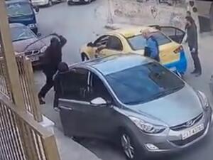 The man is seen taking a sword out of his trunk and striking the taxi driver’s arm with it before being pushed away by bystanders and a woman who was with him in the vehicle (Facebook)