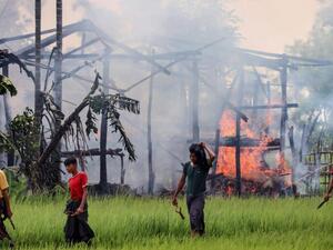The mass graves kept corpses of men half-buried with their faces burned away by acid or blasted by bullets.