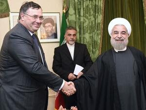 Total Chief Executive Officer Patrick Pouyanne (L) shakes hands with Iranian President Hassan Rouhani during a meeting in Paris on January 28, 2016. (Eric Fefferberg/ AFP) Total Chief Executive Officer Patrick Pouyanne (L) shakes hands with Iranian President Hassan Rouhani during a meeting in Paris on January 28, 2016. (Eric Fefferberg/ AFP)