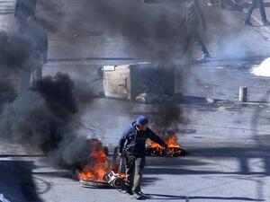 Tunisian demonstrators block the road with burning tires in the central city of Kasserine during protests, on 21 January, 2016, triggered by the death of an unemployed man. (AFP/ Mohamed Khalil) Tunisian demonstrators block the road with burning tires in the central city of Kasserine during protests, on 21 January, 2016, triggered by the death of an unemployed man. (AFP/ Mohamed Khalil)