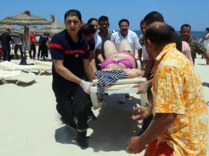 Tunisian medics carry a woman on a stretcher in the resort town of Sousse, south of the Tunisian capital. (AFP/File)