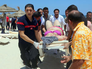 Tunisian medics carry a woman on a stretcher in the resort town of Sousse after an IS-related attack on June 27, 2015. The attack killed nearly 40 people, most of them British tourists. (AFP) Tunisian medics carry a woman on a stretcher in the resort town of Sousse after an IS-related attack on June 27, 2015. The attack killed nearly 40 people, most of them British tourists. (AFP)
