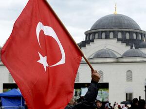Supporters wave flags as they watch as Turkey's President Recep Tayyip Erdogan inaugurates the Diyanet Islamic Cultural Center in Lanham, Maryland on April 2, 2016. (Olivier Douliery)