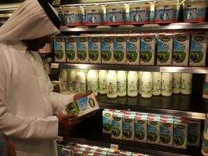 A customer reads the label on a Turkish dairy product at a supermarket in Doha. (The Peninsula)