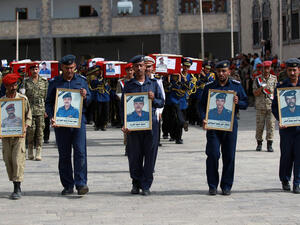 Honor guard soldiers carry the portraits and the coffins of military officers during their funeral ceremony (AFP/ MOHAMMED HUWAIS)