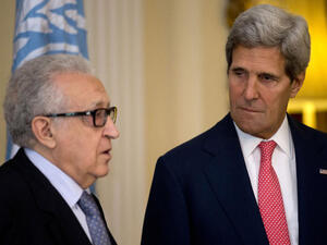  U.N-Arab League envoy for Syria Lakhdar Brahimi (L) speaks as U.S. Secretary of State John Kerry looks on after their meeting at Winfield House (Image credit: AFP)